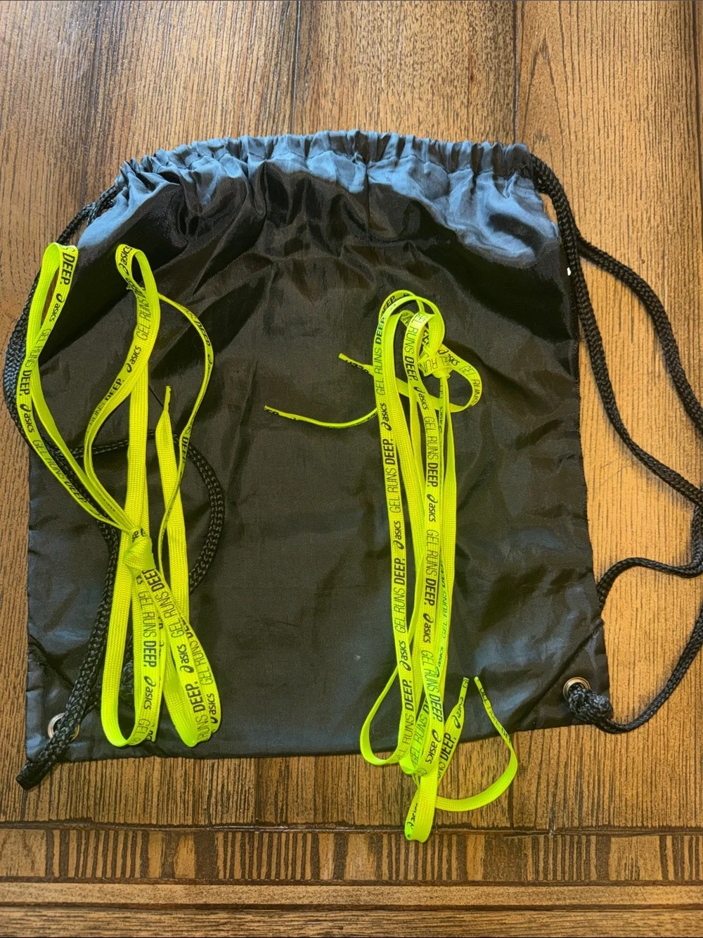 Asics Black Drawstring Backpack with Two Pairs of Neon Yellow Laces